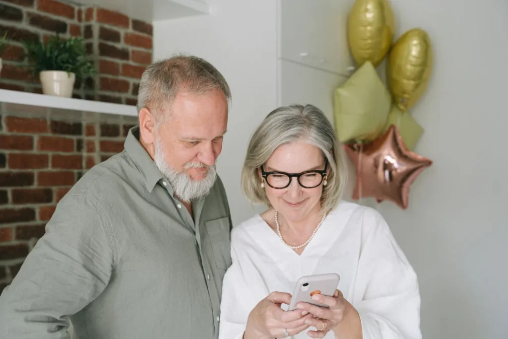 Senior couple enjoying a video call at home, sharing a warm moment together.
